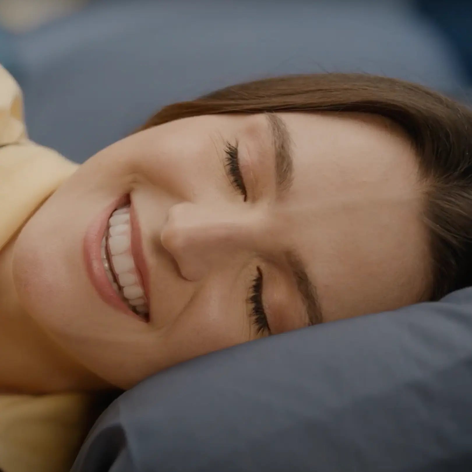 Close-up of a woman lying down with a smile on her face