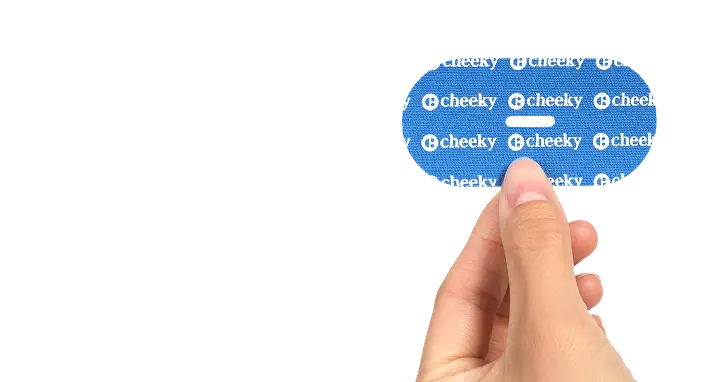 Blue 'cheeky' label held by a hand on a white background