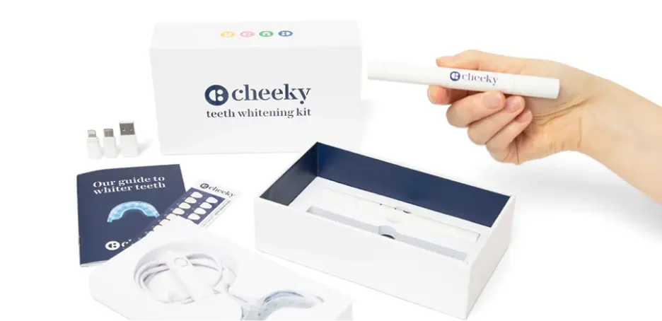Cheeky teeth whitening kit with a hand holding a pen and packaging on a white background